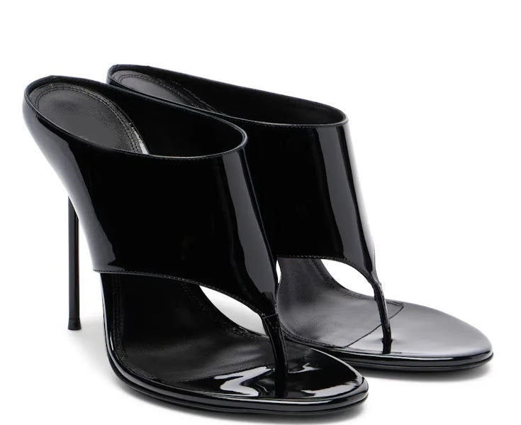 Black patent leather stiletto mule heels with wide structured upper and open toe thong detail