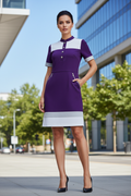 Purple and white color block shift dress styled with black pumps in city setting